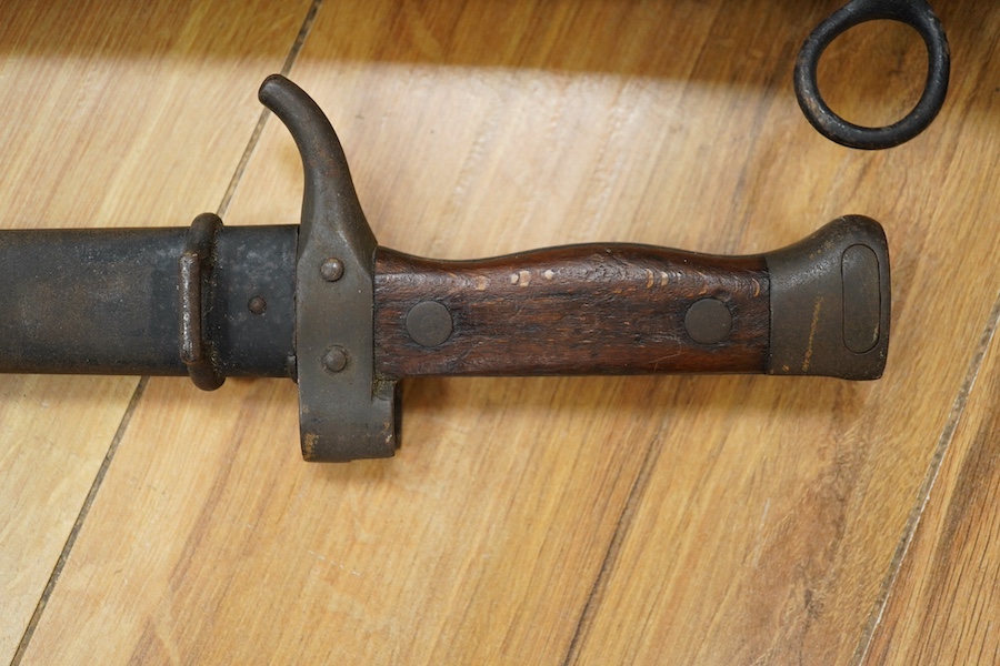 A First World War Turkish army officer’s sword, with pipe back blade, regulation iron guard pierced with crescent and moon, chequered horn grips, in its iron scabbard, together with an unidentified bayonet in its scabbar